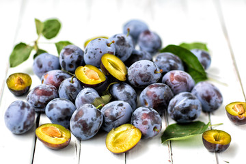 blue plums on light wooden background.fruits.the view from the top	
