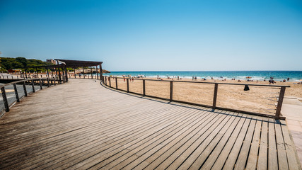 Obraz premium Vacationers in Arrabassada Beach, one of the famous golden sand beaches in the Spanish Costa Daurada