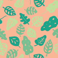 Leaves seamless vector background. Leaves in shades of green on a pink coral peachy background. Hand drawn tropical leaves pattern. Jungle leaf. Illustration for wrapping, fabric, paper, kids, web