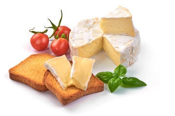 Round camembert cheese with a cut out piece and crispy toasters, isolated on white background.