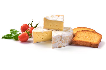 Round camembert cheese with a cut out piece and crispy toasters, isolated on white background.