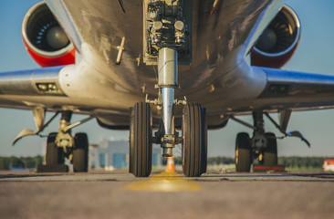 jet's front nose landing gear at the airport - obrazy, fototapety, plakaty