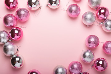 Pink and silver christmas balls on a paper background. Top view, flat lay, copy space