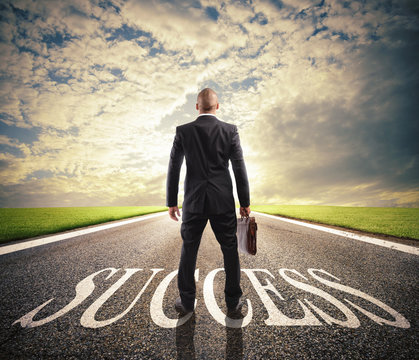 Man walks on a success way. Concept of successful businessman and company startup