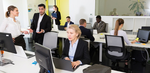 Business people working in open plan office