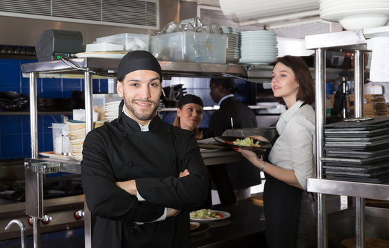 Bearded chef in kitchen of restaurant