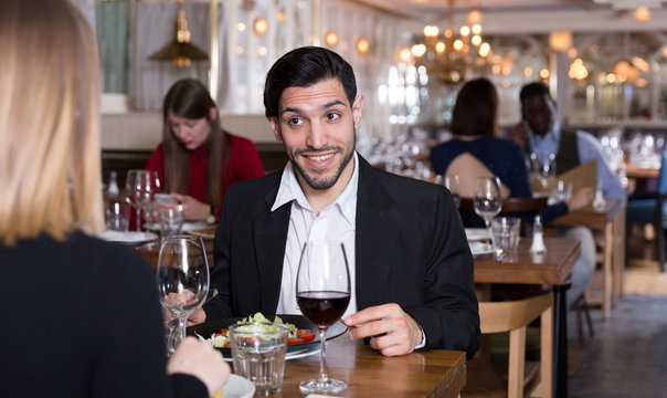 Cheerful man with female in restaurant