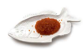 Red salmon caviar on a fish-shaped plate, isolated on white
