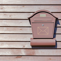 Mail box on the wooden fence.