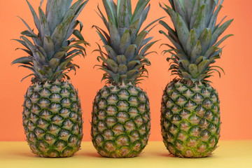 3 whole fresh pineapples in a row