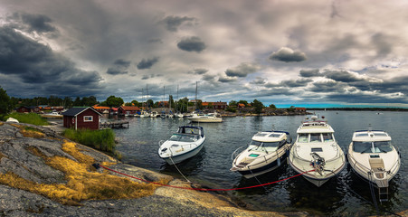 Swedish Archipelago - June 23, 2018: Boats in the harbor in the island of Moja in the Swedish Archipelago during Midsummer, Sweden