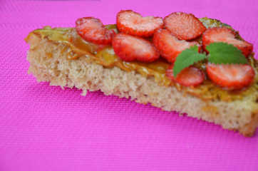 photo of delicious tasty strawberry sandwich. a sandwich with strawberries and peanut butterflies on a crimson background. top view, copy space. a healthy snack