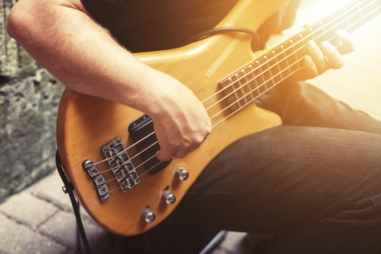 the man is playing the guitar
