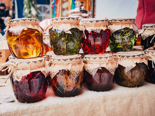 honey infused on various herbs and plants, mushrooms and jam on the market. Healthy food for the wintertime