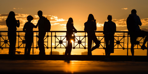 Fototapeta na wymiar People looking on sunset