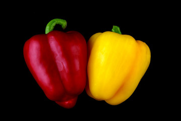 Red and Yellow Capsicums Isolated on a Black Background