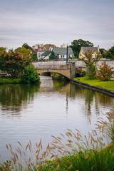 Fototapeta na wymiar Bridge and island in Sunset Lake, Asbury Park, New Jersey.