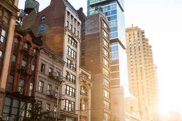 Historic buildings on 23rd Street in Manhattan New York City with sunlight background