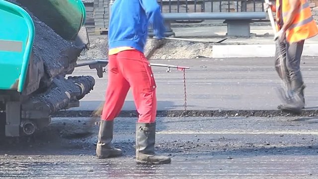 asphalt laying on a city street, road repair