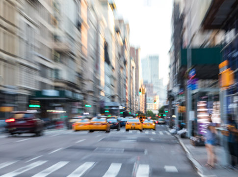 Fast moving taxis on Fifth Avenue in Manhattan New York City blurred background