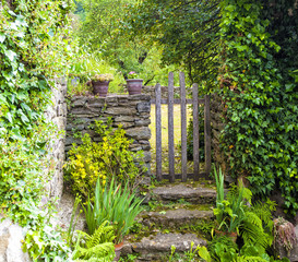 Wooden gate in a stone wall on a farm