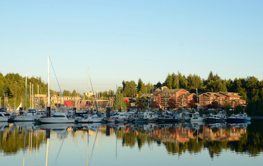 Fototapeta na wymiar Ucluelet Harbor with Boats and Reflection at Sunset
