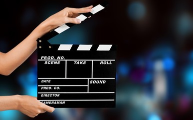 Cinema clapperboard in female hands