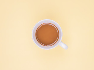Top view coffee cup on yellow background. Flat lay design and copy space. Pastel color tone