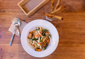 Spaghetti with Seafood isolated on wood Background
