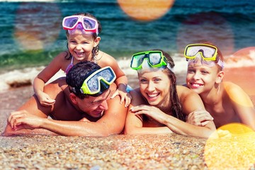 Obraz na płótnie Canvas Happy family on vacations on beach
