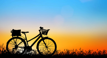 silhouette vintage bike on sunrise.
