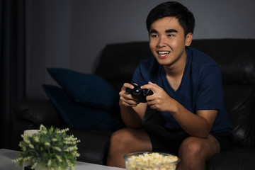 happy man playing video games at night