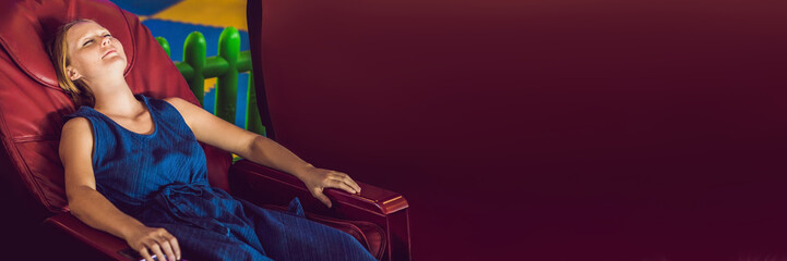 Beautiful young lady relaxing in the massage chair BANNER, long format