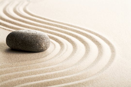 Zen stones in the sand. Grey background