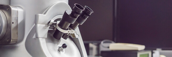 a transmission electron microscope in a scientific laboratory BANNER, long format