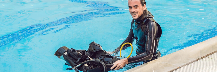 Portrait of a happy diving instructor, ready to teach diving in the pool BANNER, long format