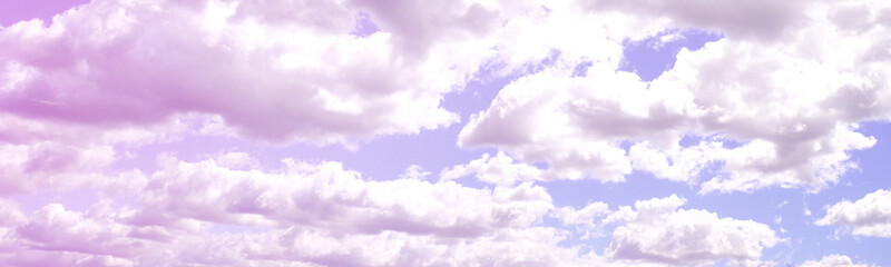 A blue sky with lots of white clouds of different sizes