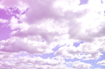 A blue sky with lots of white clouds of different sizes