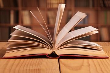 Open book on old wooden table