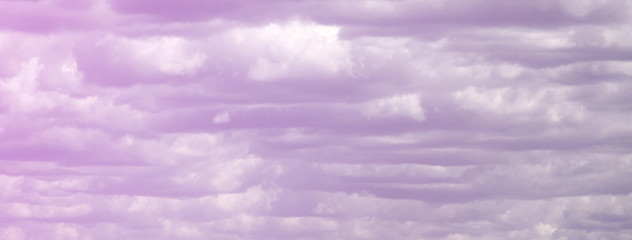 A blue sky with lots of white clouds of different sizes