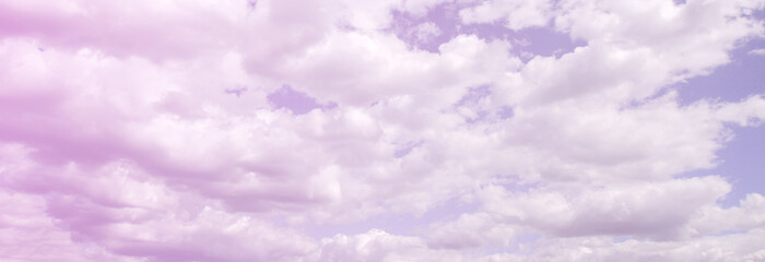 A blue sky with lots of white clouds of different sizes