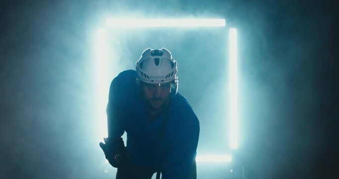 FIXED Portrait of Caucasian male ice hockey player in uniform, looking into the camera, dramatic lighting. 4K UHD 60 FPS SLOW MOTION