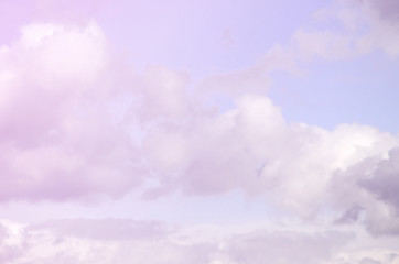 A blue sky with lots of white clouds of different sizes