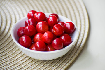 Fresh Cherries in a white ceramic bowl. Fresh breakfast concept. Sweet cherries. Fresh ripe cherries.