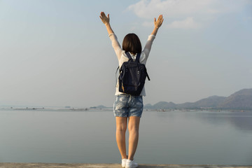 Behind backpack Asian women on the Krasiew dam ,Dan chang Suphan Buri Thailand