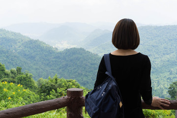 Behind backpack Asian women Mountain sky background