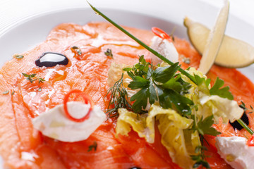 Carpaccio , salmon filet salad. Summer launch, healthy eating concept. white plate with sauce. salad served in asian style