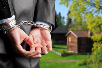 Cropped image of male hands in handcuffs