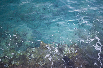 Clear blue sea water and rocks
