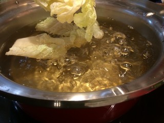 Hot soup boiling with vegetable in a pot.